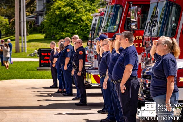 Wadsworth firefighters stand at attention beside their engine
