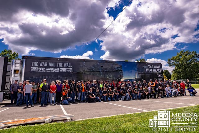 Hundreds of escort riders assembled in front of the Wall for a group photograph