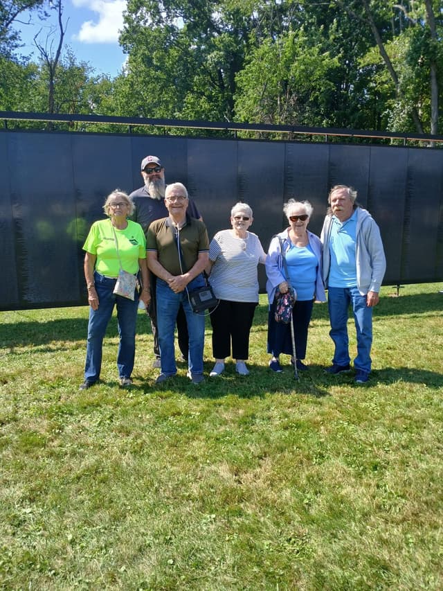 A group of visitors pauses for a photograph in front of the Wall