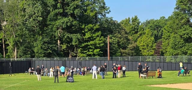 Visitors gathered along the Wall on a bright afternoon