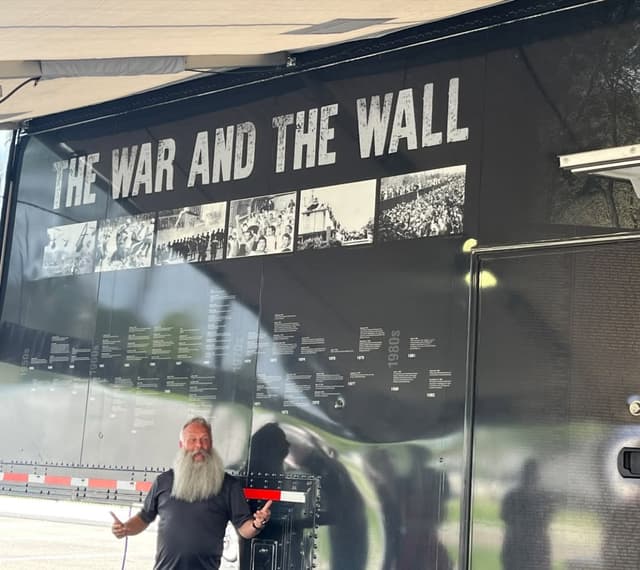 A visitor at The War and the Wall exhibit